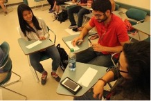 students sitting at desks in a group setting