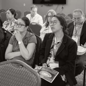 Instructors sitting in a seminar listening to a speaker