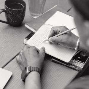 Someone writing in a notebook