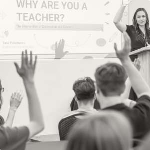 Instructor at podium looking at class