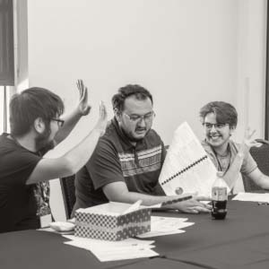 Three people working together and smiling